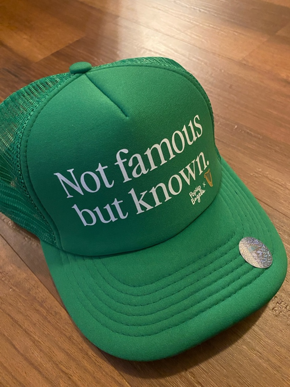 Green 'Not famous but known.' Trucker Hat